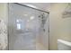 Modern, glass enclosed shower with grab bar and handheld shower fixture at 400 Laurel Lake Dr # 104, Venice, FL 34292