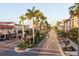 Beautiful street with palm trees in the middle of the road with shops around at 400 Laurel Lake Dr # 104, Venice, FL 34292