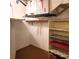 Unfinished basement area with open shelving, exposed ceiling fixtures, and a carpeted floor at 435 S Gulfstream Ave # 605, Sarasota, FL 34236