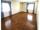 Spacious bedroom with parquet wood flooring, large windows, and blue curtains, offering plenty of natural light at 435 S Gulfstream Ave # 605, Sarasota, FL 34236