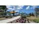 Community park showcasing a playground with sail-shaped shade structures and cactus design structures in a landscaped area at 435 S Gulfstream Ave # 605, Sarasota, FL 34236