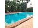 Large community pool with bright turquoise water and surrounding landscaping, offering a refreshing outdoor space at 435 S Gulfstream Ave # 605, Sarasota, FL 34236