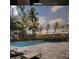 Rendering of a community pool with lounge chairs and shade canopies, surrounded by palm trees and lush landscaping at 435 S Gulfstream Ave # 605, Sarasota, FL 34236