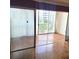 Well-lit living room with parquet floors, sliding glass doors leading to a balcony, and sheer white curtains at 435 S Gulfstream Ave # 605, Sarasota, FL 34236