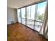 Bright living room with parquet floors, large windows offering city views, and sheer white curtains at 435 S Gulfstream Ave # 605, Sarasota, FL 34236