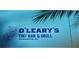 Sign for O'Leary's Tiki Bar & Grill featuring a Tiki design, set against a tropical-themed background at 435 S Gulfstream Ave # 605, Sarasota, FL 34236