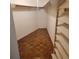 Small walk-in closet with parquet floors, white walls, and bifold doors at 435 S Gulfstream Ave # 605, Sarasota, FL 34236