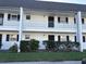 Charming two-story condo with black shutters, white railings, and well-maintained landscaping at 4502 3Rd Street W Cir # 242, Bradenton, FL 34207