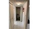 Hallway with tiled floor and large storage closet with cleaning equipment, including fire extinguisher at 4502 3Rd Street W Cir # 242, Bradenton, FL 34207