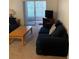 Comfortable living room area with sliding glass door and plenty of sunlight at 4502 3Rd Street W Cir # 242, Bradenton, FL 34207