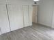 Bedroom with spacious closet, ceiling fan, and wood-look tile flooring at 4505 3Rd Street W Cir # 269, Bradenton, FL 34207