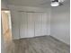 Well-lit bedroom with wood-look tile flooring and closet at 4505 3Rd Street W Cir # 269, Bradenton, FL 34207