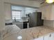 Renovated kitchen with white cabinets, quartz countertops, and stainless steel appliances at 4505 3Rd Street W Cir # 269, Bradenton, FL 34207