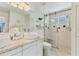 Modern bathroom with double sink vanity, walk-in glass shower, and sleek fixtures at 4911 Commonwealth Rd, Palmetto, FL 34221