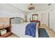 Bright bedroom with wood bed frame, blue accents, and a view to the ensuite bath at 4911 Commonwealth Rd, Palmetto, FL 34221