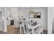 Bright dining area features modern lighting and a view into the updated kitchen area at 4911 Commonwealth Rd, Palmetto, FL 34221