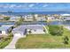 Charming waterfront home featuring a lush green lawn, well-maintained landscaping, and access to the beautiful blue waters beyond at 4911 Commonwealth Rd, Palmetto, FL 34221