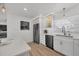 Kitchen with stainless appliances, white cabinets and a view into the living room at 4911 Commonwealth Rd, Palmetto, FL 34221