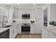 Modern kitchen features white cabinetry, stainless steel appliances and recessed lighting at 4911 Commonwealth Rd, Palmetto, FL 34221
