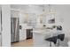 Bright kitchen with white cabinets, stainless appliances and a breakfast bar at 4911 Commonwealth Rd, Palmetto, FL 34221