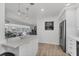 Bright kitchen with white cabinets, stainless steel appliances and views to living areas at 4911 Commonwealth Rd, Palmetto, FL 34221