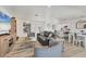 Spacious living room with sleek furniture, a large TV, and an open layout flowing into the dining area for easy entertaining at 4911 Commonwealth Rd, Palmetto, FL 34221