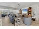 Bright living room with modern furniture, a large flat-screen TV, and large windows offering an inviting living space at 4911 Commonwealth Rd, Palmetto, FL 34221