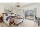 Comfortable main bedroom with sliding door and outdoor view, accented with stylish decor at 4911 Commonwealth Rd, Palmetto, FL 34221