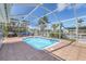 Inviting outdoor pool with seating, barbecue, screened enclosure and lovely landscaping at 4911 Commonwealth Rd, Palmetto, FL 34221