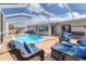 Inviting pool area with outdoor seating, sunny skies, and a screened enclosure at 4911 Commonwealth Rd, Palmetto, FL 34221