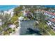 Beautiful aerial view of the community and tennis courts with lush greenery and the beach nearby at 5055 Gulf Of Mexico Dr # 435, Longboat Key, FL 34228