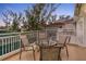 A cozy outdoor balcony with comfortable seating area, overlooking the complex and tennis court at 5055 Gulf Of Mexico Dr # 435, Longboat Key, FL 34228