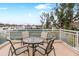 Spacious balcony with seating offers views of the community and nearby tennis courts at 5055 Gulf Of Mexico Dr # 435, Longboat Key, FL 34228