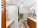 Well-lit bathroom featuring double vanity with a marble countertop and light wood cabinetry at 5055 Gulf Of Mexico Dr # 435, Longboat Key, FL 34228