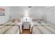 This cozy bedroom features two twin beds, neutral carpeting and plenty of natural light at 5055 Gulf Of Mexico Dr # 435, Longboat Key, FL 34228