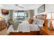Cozy bedroom with a queen size bed and balcony access offering views of the intercoastal waterway at 5055 Gulf Of Mexico Dr # 435, Longboat Key, FL 34228
