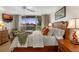 Cozy bedroom with a queen size bed and balcony access offering views of the intercoastal waterway at 5055 Gulf Of Mexico Dr # 435, Longboat Key, FL 34228