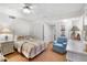 This comfortable bedroom features carpet, a ceiling fan, closet, and a nightstand with bedside lamp at 5055 Gulf Of Mexico Dr # 435, Longboat Key, FL 34228