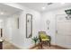 Inviting entryway with a charming vintage decor, white door and a rustic tennis racket wall hanging at 5055 Gulf Of Mexico Dr # 435, Longboat Key, FL 34228