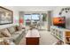 Bright living room features neutral decor, plush seating, and a large sliding door to the outdoor patio at 5055 Gulf Of Mexico Dr # 435, Longboat Key, FL 34228
