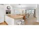 Open concept living space with island and bar seating extending into the dining and living rooms at 5055 Gulf Of Mexico Dr # 435, Longboat Key, FL 34228