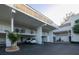 Exterior of the building featuring covered parking and white railings at 5055 Gulf Of Mexico Dr # 435, Longboat Key, FL 34228