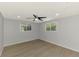 A bright bedroom with a ceiling fan, hardwood floor and sun-filled windows at 510 S Venice Blvd, Venice, FL 34293