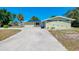 Single story home featuring an attached garage and large concrete driveway at 510 S Venice Blvd, Venice, FL 34293