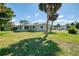 A corner lot with tropical palms frames this home in a beautiful, lush green setting at 510 S Venice Blvd, Venice, FL 34293