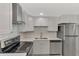 Modern kitchen showcases white subway tile backsplash and stainless steel appliances at 510 S Venice Blvd, Venice, FL 34293