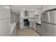 Modern kitchen with stainless steel appliances, white cabinets, and updated countertops at 510 S Venice Blvd, Venice, FL 34293