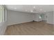 Open living room featuring wood floors, a ceiling fan, and natural light from the windows at 510 S Venice Blvd, Venice, FL 34293
