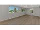 Bright living room with large windows, ceiling fan, and wood-look floors at 510 S Venice Blvd, Venice, FL 34293