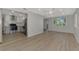 Open concept living area features wood-look flooring, recessed lighting, and a kitchen view at 510 S Venice Blvd, Venice, FL 34293